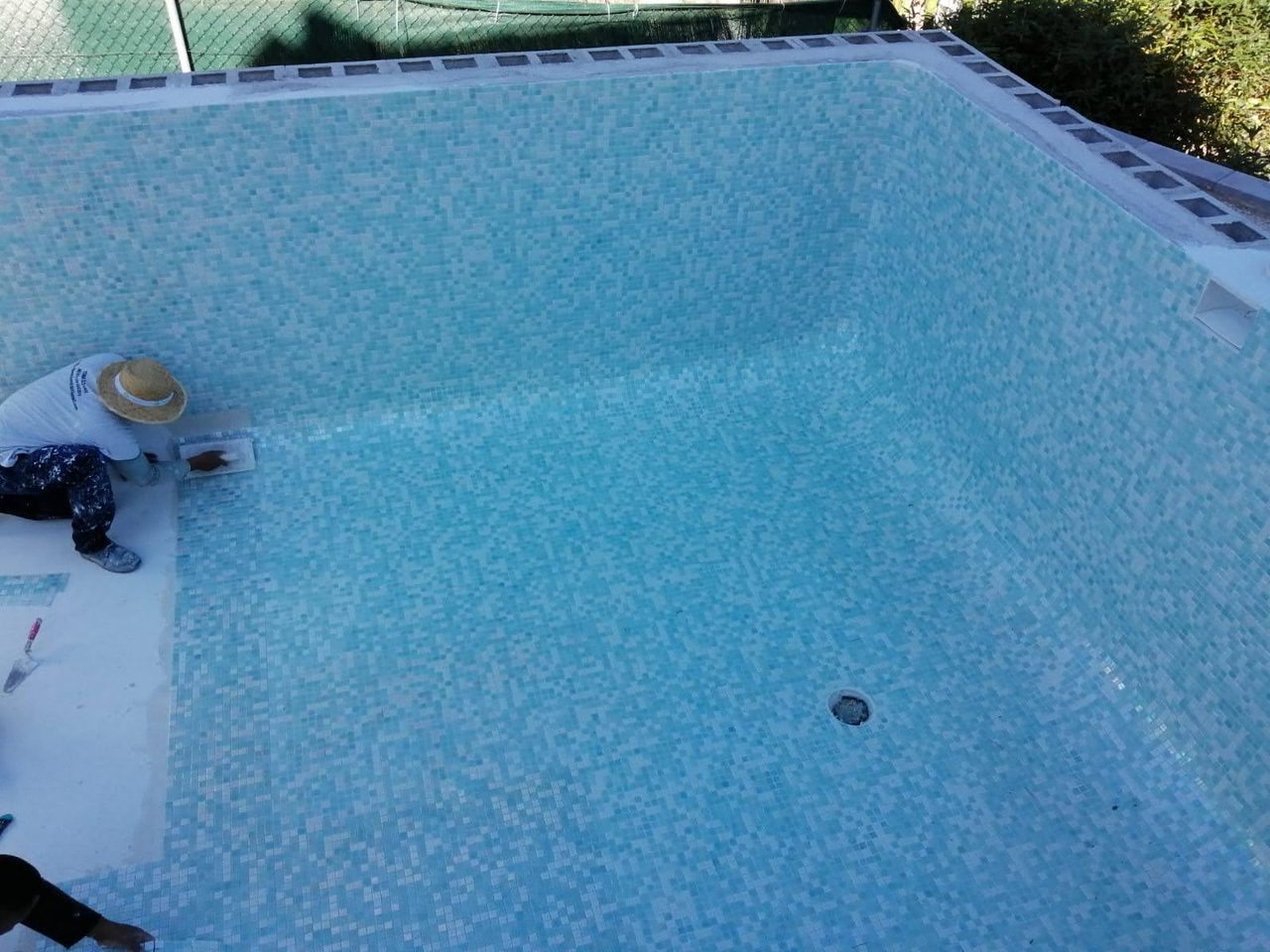 Finished concrete pool with blue mosaic tiling